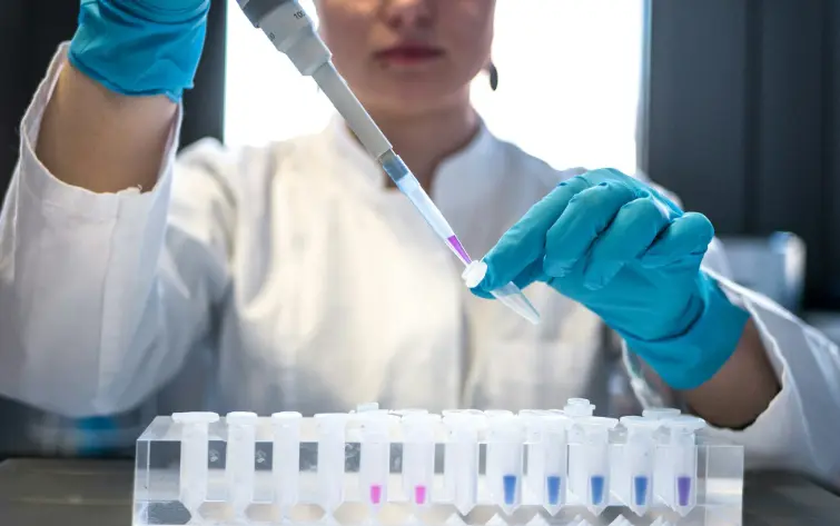 person filling test tube